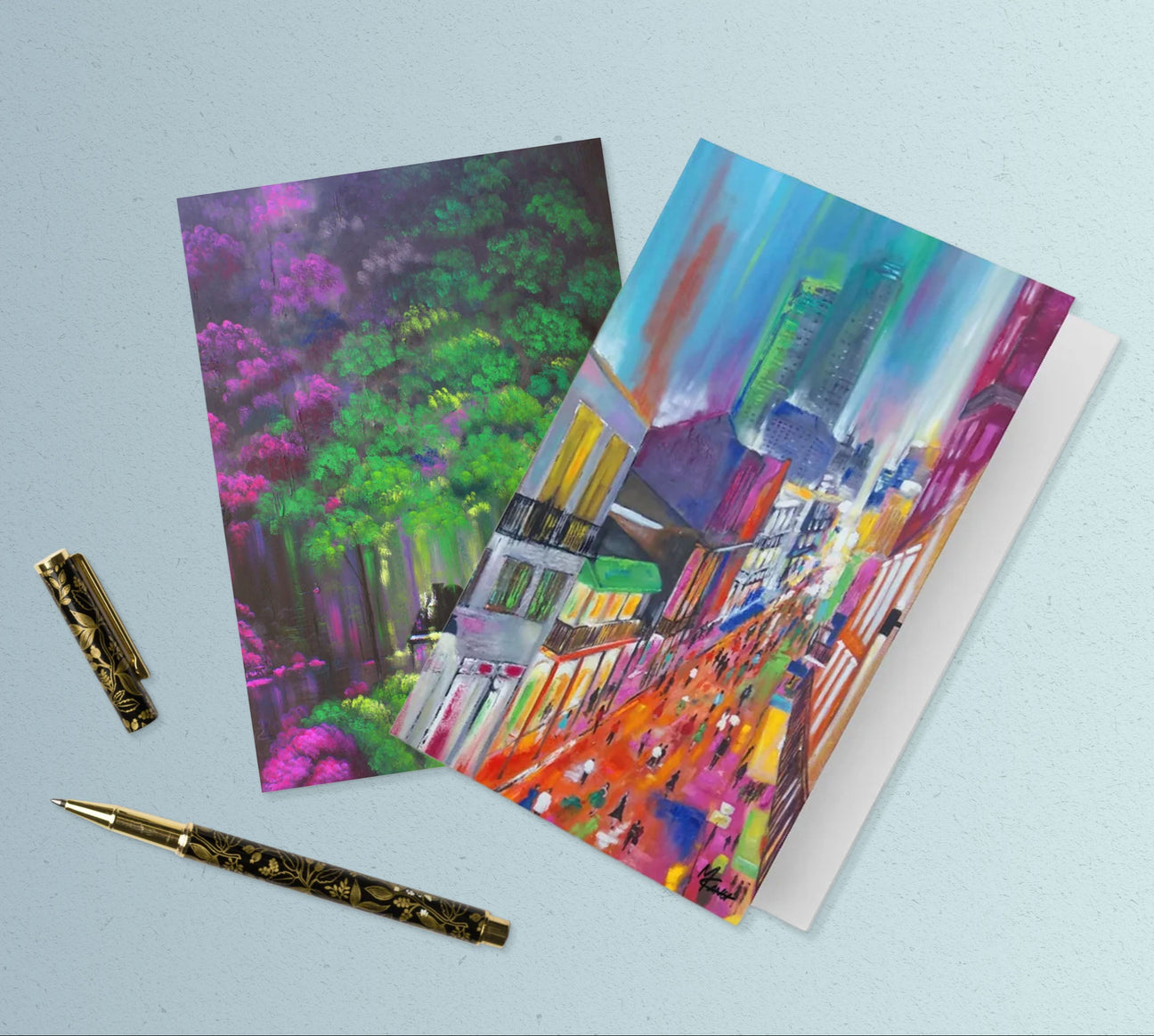 Colorful greeting cards with artistic designs on a light blue background
